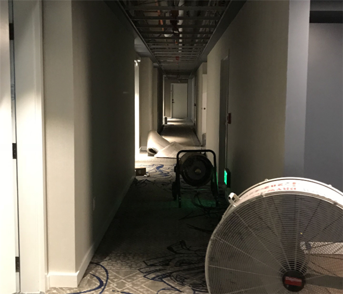 Water damage in an office building hallway.