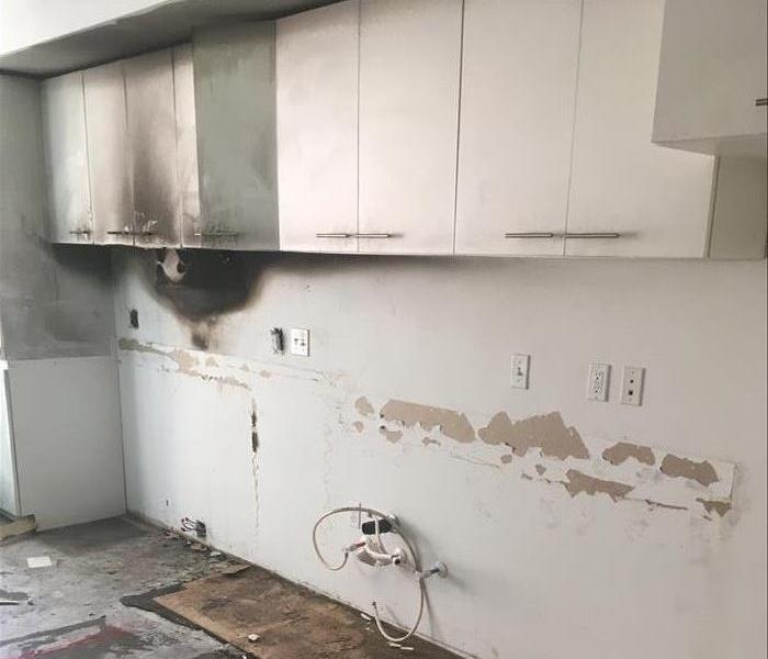 Fire damage in apartment complex kitchen.