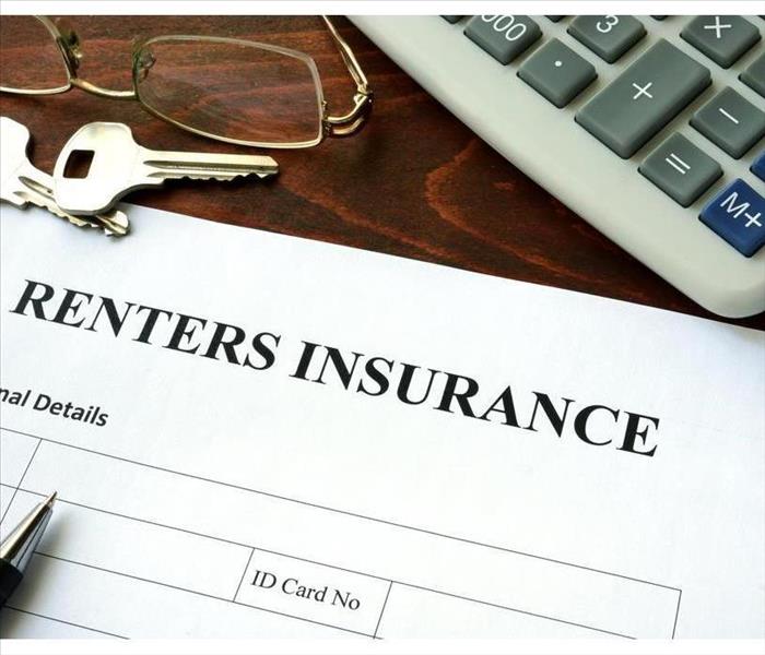 Renters insurance form and dollars on the table.